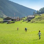 Kinder laufen auf der Alm